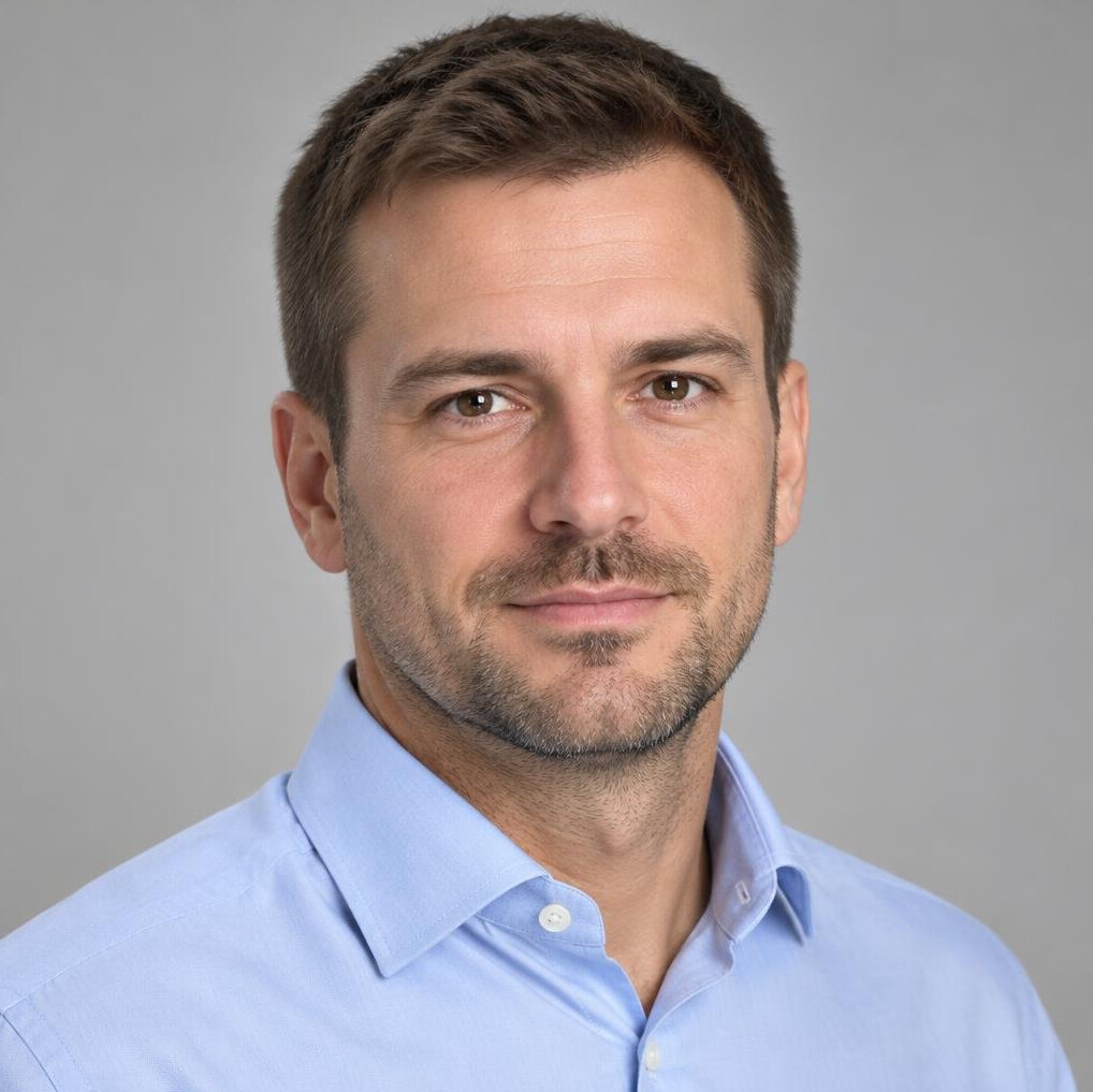 Portrait of a man with short hair in a collared shirt
