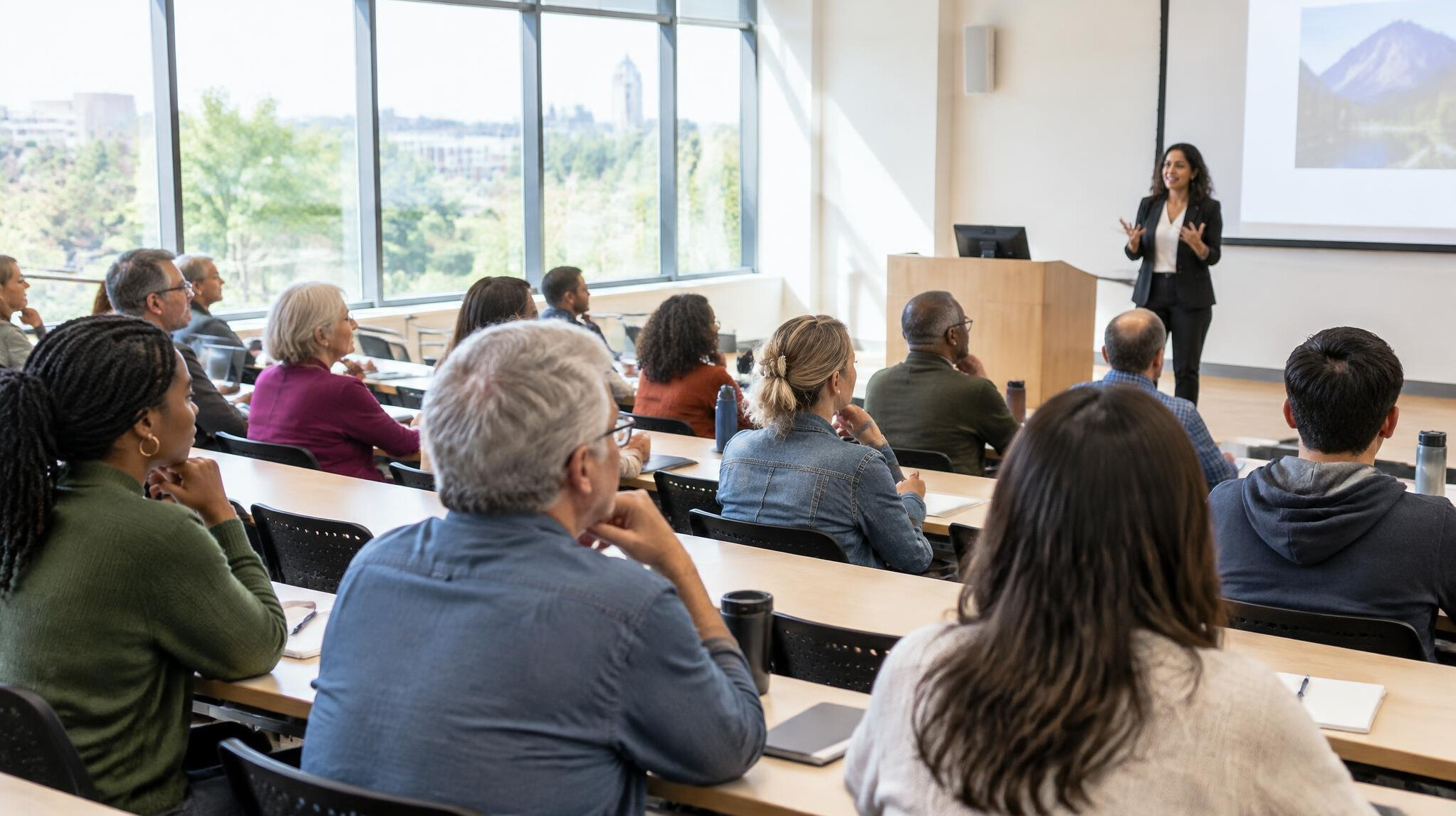 Adult learners attending a lecture in a bright hall