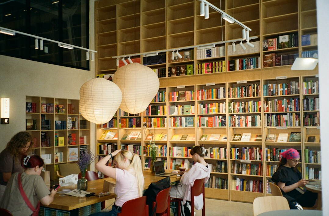 Adults studying together at a table with books