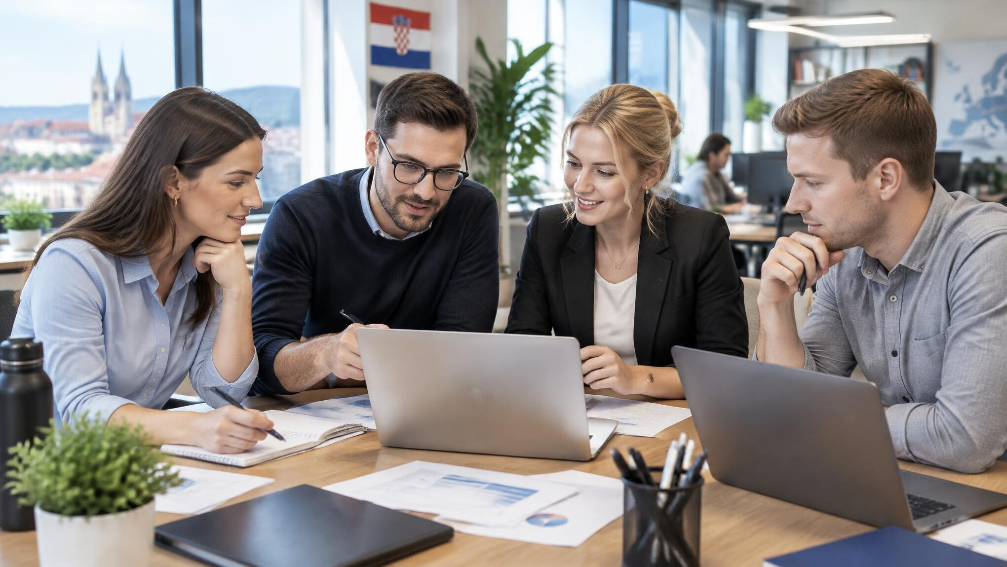 Colleagues collaborating around a shared desk